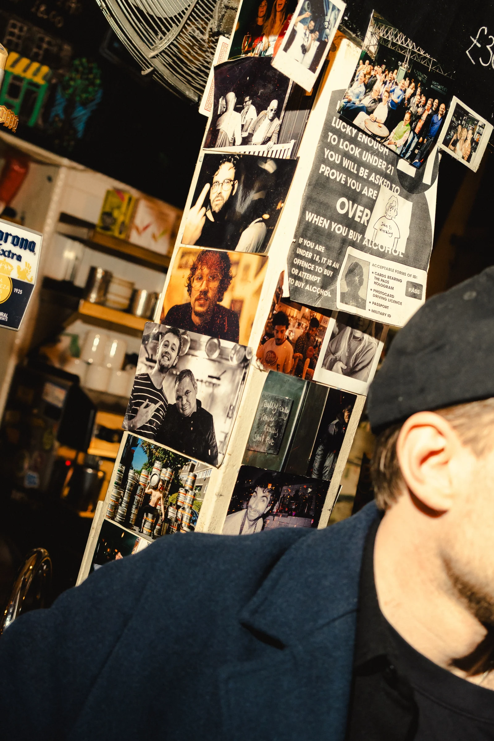 Campaign posters on a pub wall behind a seated guest