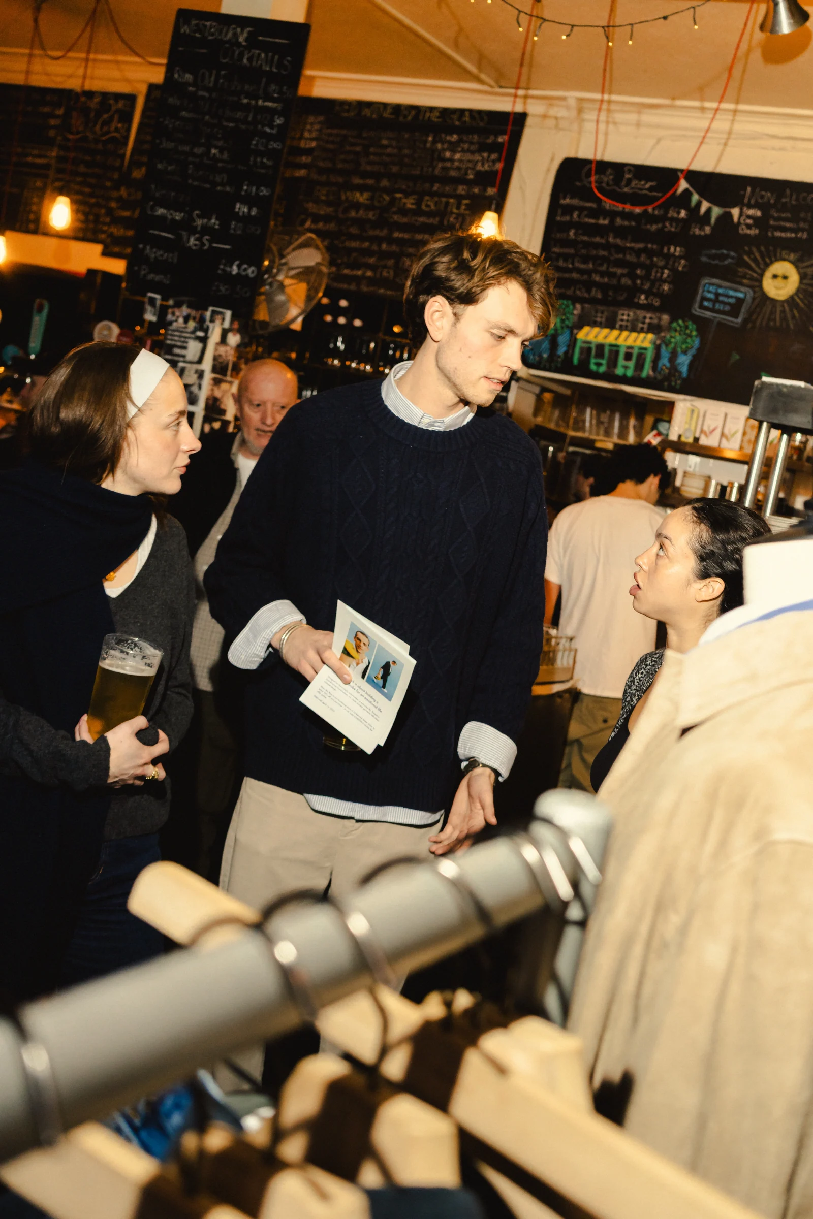 Guest holding campaign material beside the clothing display