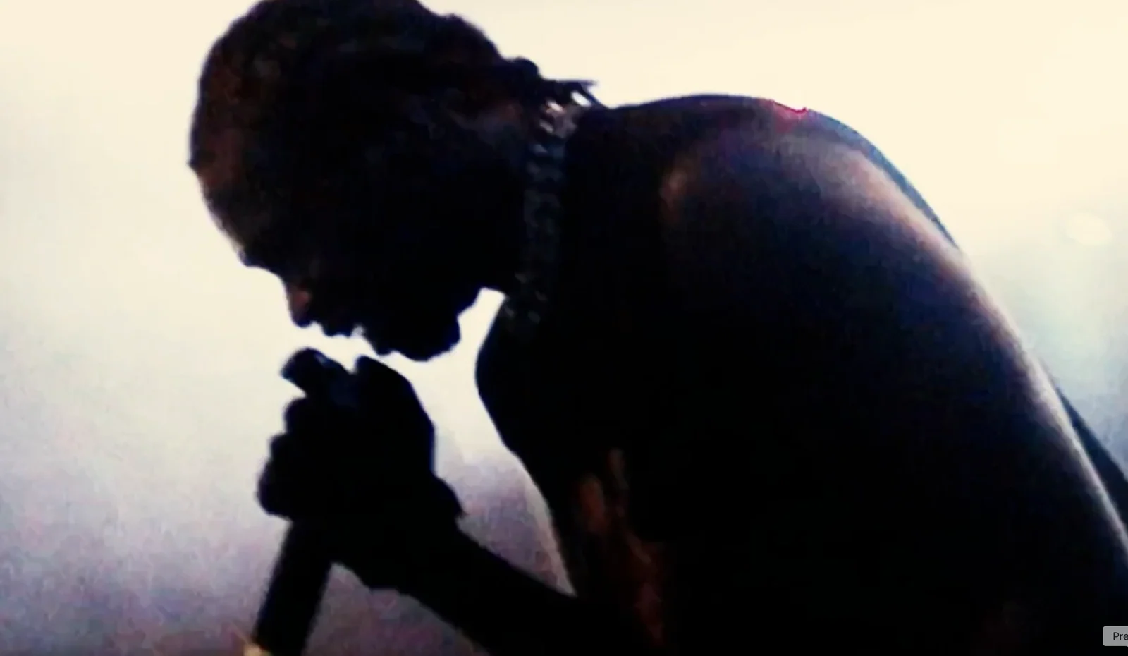 Singer holding a microphone in silhouette