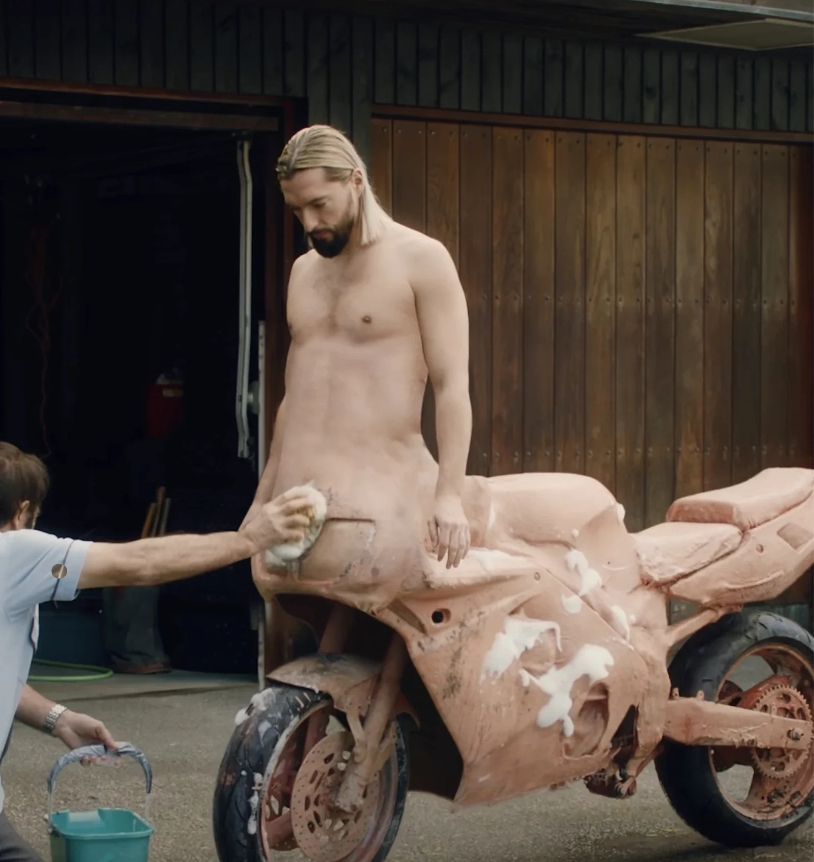 Model and sculptural pink motorcycle on a creative production set