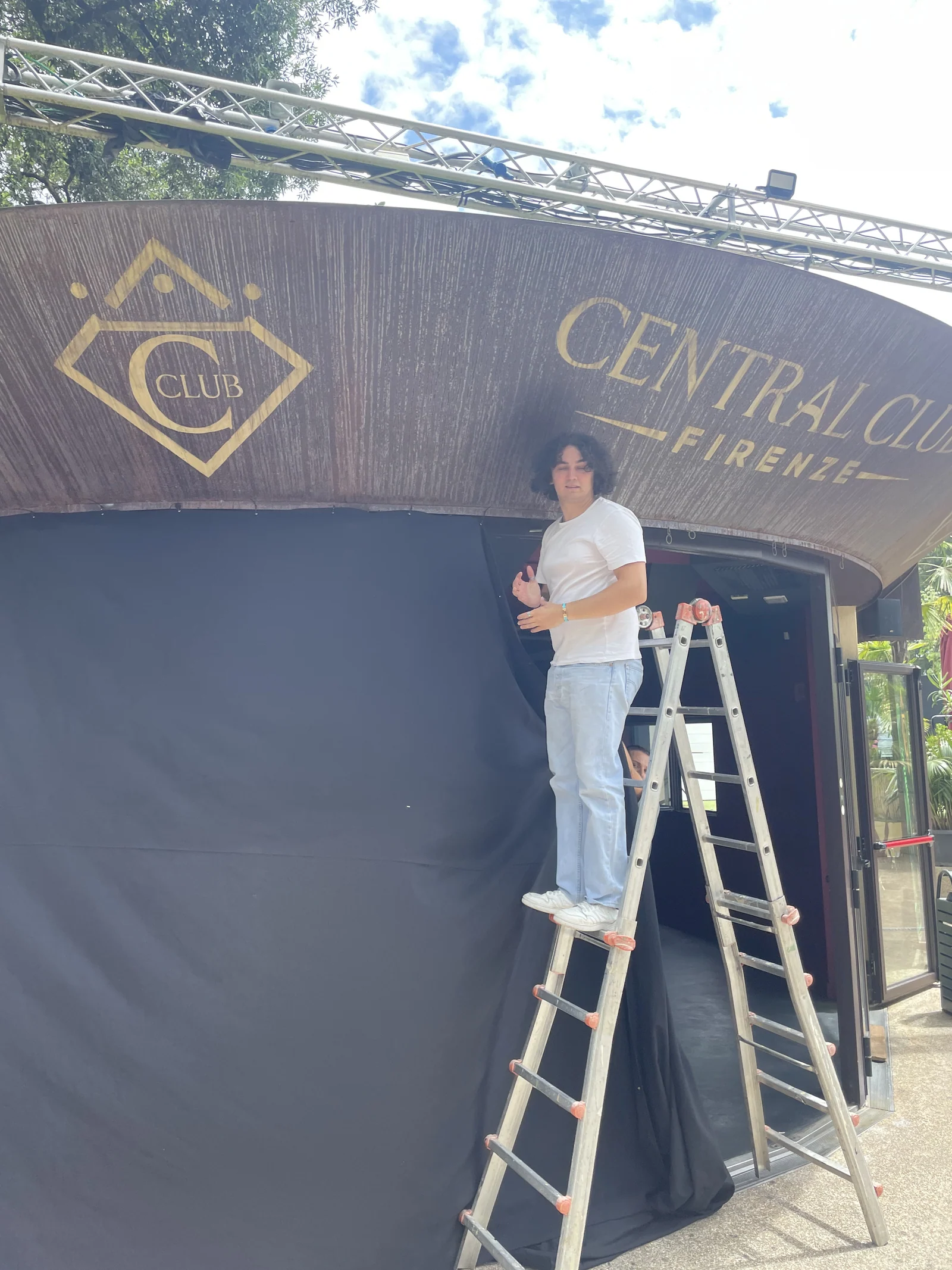 Crew member on a ladder installing the show backdrop