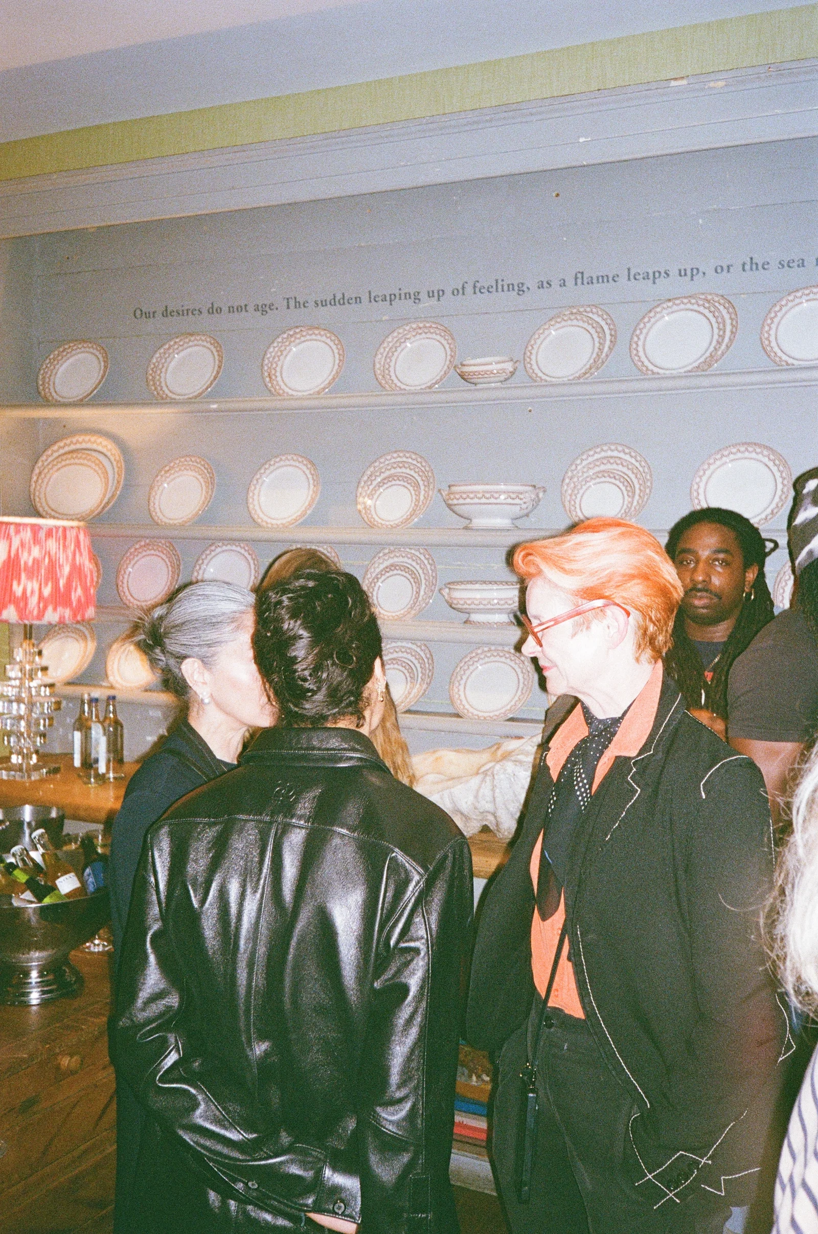 Guests talking beneath chandeliers at a film festival reception