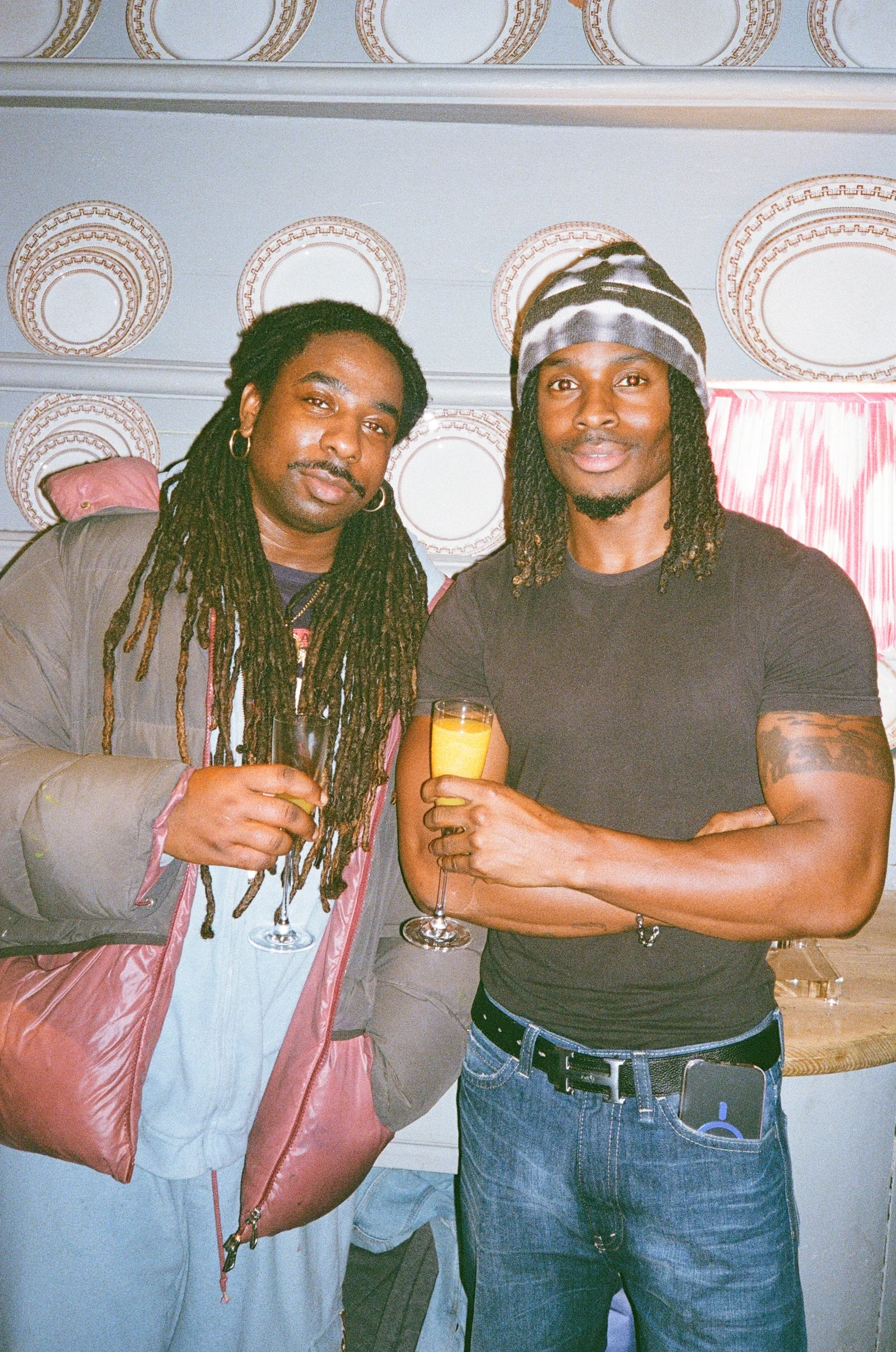 Two guests holding drinks at a film festival party