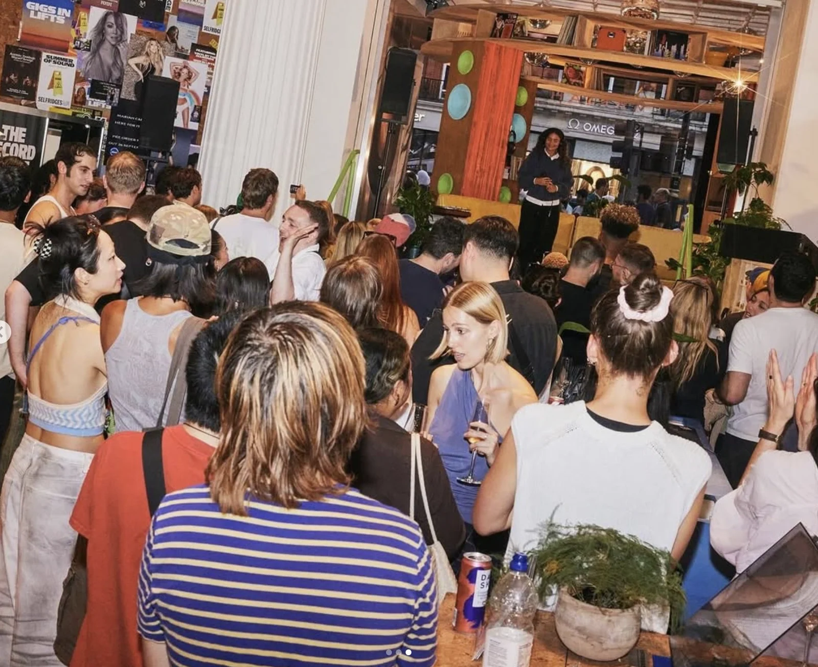 Audience gathered around a live performance at Selfridges